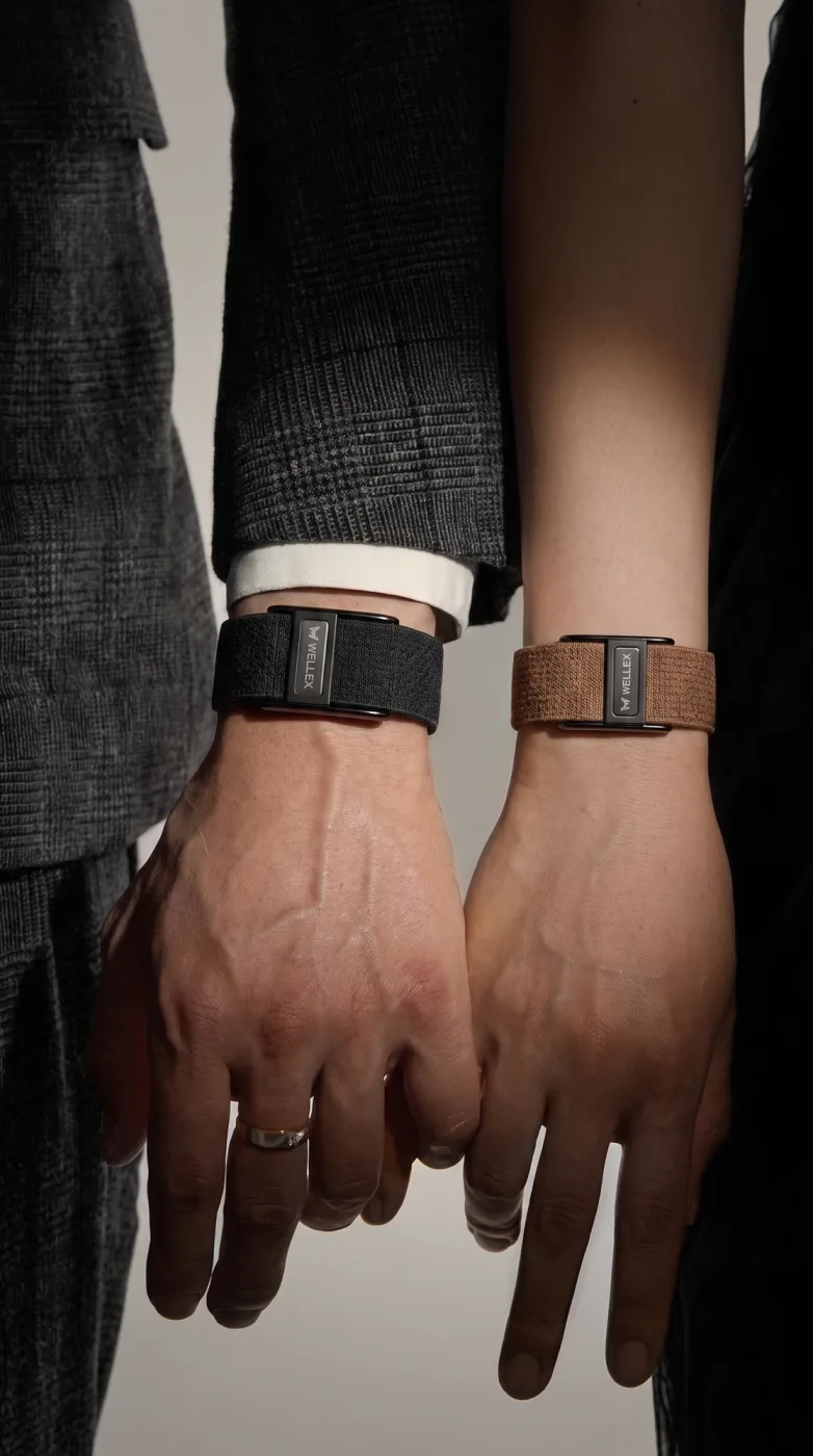 A couple holding hands, bands on both wrists