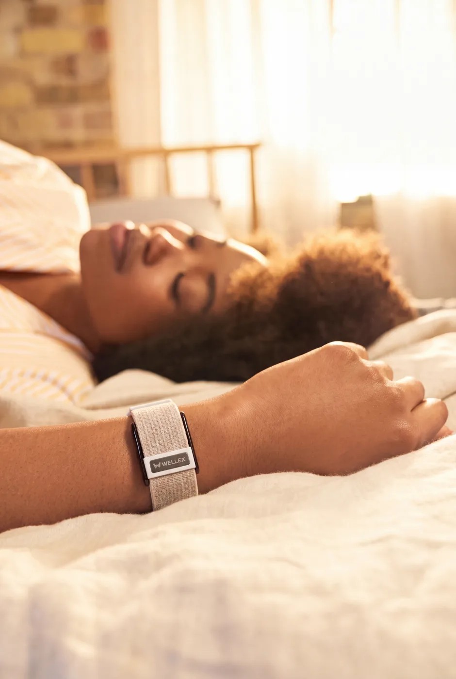 A woman asleep wearing a Wellex band
